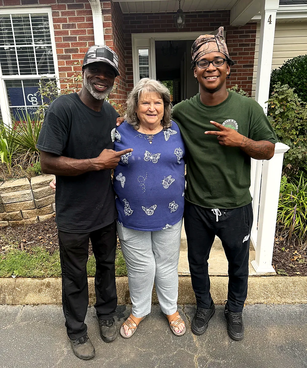 A Carter's Moving customer with two crew members after her move in Greenville SC