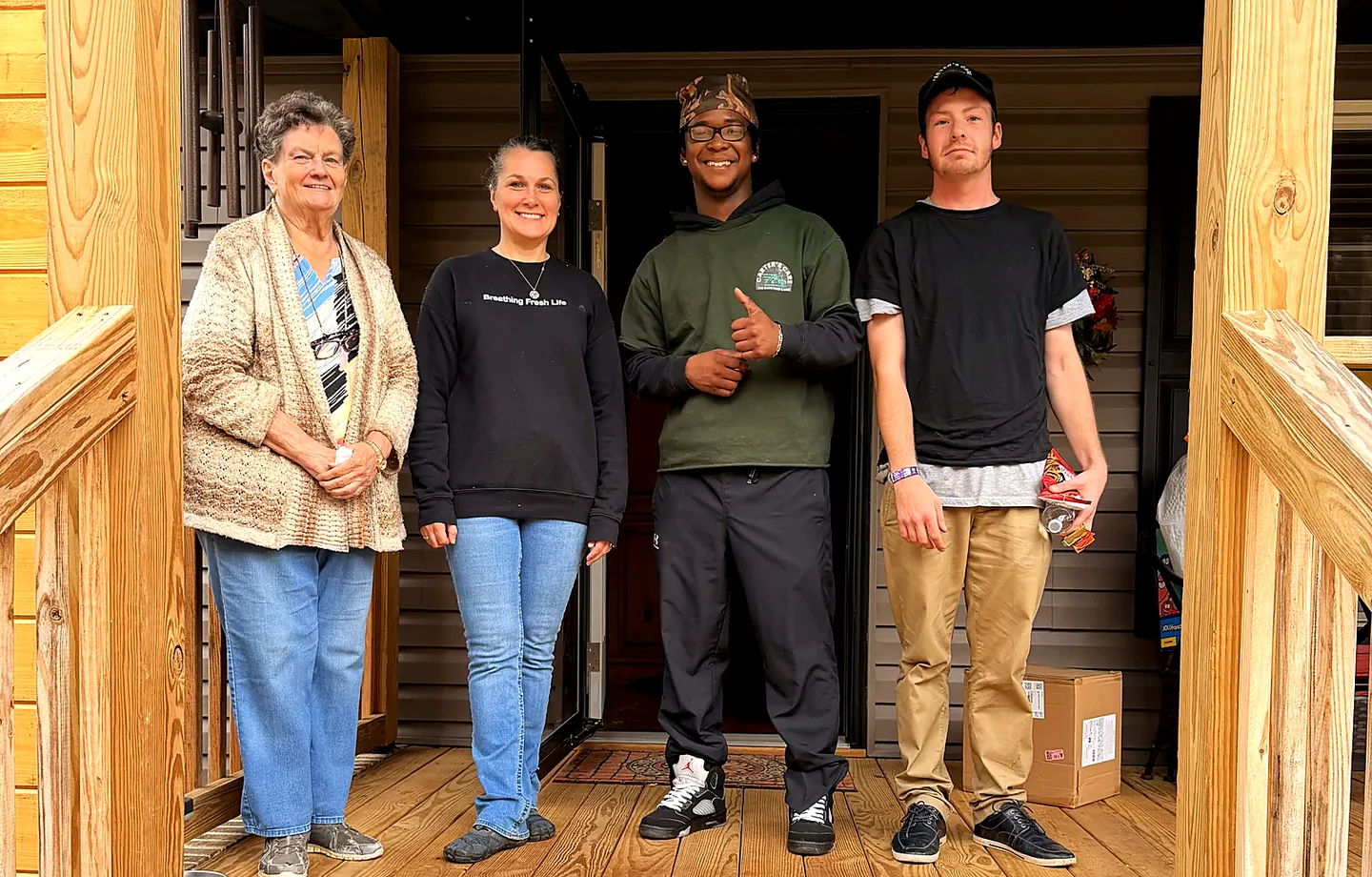 A Carter's Moving crew with a customer at her front door in Greenville SC